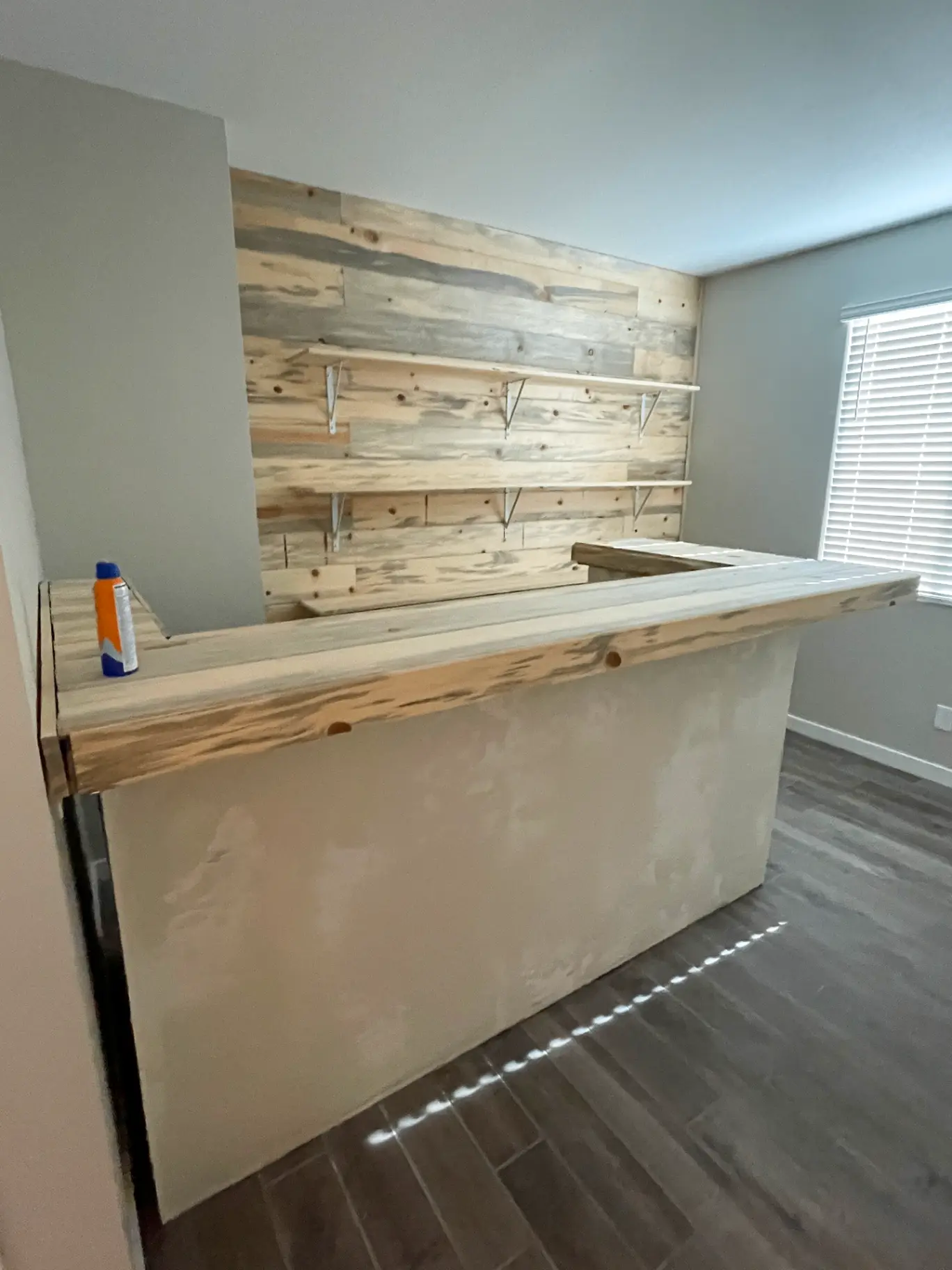 Custom wood home bar in a Phoenix living room finished with a warm hand rubbed stain that resists everyday wear